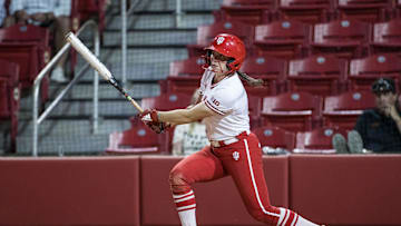 May 17, 2025; Fayetteville, AR, USA;  Indiana Hoosiers infielder Madalyn Strader (8) hits a single during the fifth inning against the Oklahoma State Cowgirls.  Oklahoma State won 16-8.  Mandatory Credit: Brett Rojo-Imagn Images