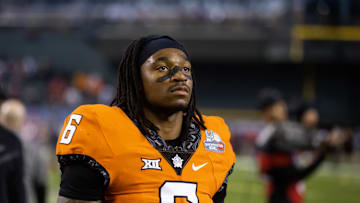Dec 27, 2022; Phoenix, Arizona, USA; Oklahoma State Cowboys safety Lyrik Rawls (6) against the Wisconsin Badgers during the 2022 Guaranteed Rate Bowl at Chase Field. Mandatory Credit: Mark J. Rebilas-Imagn Images