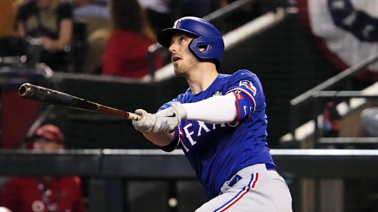 Texas Rangers catcher Mitch Garver (18) hits a fly ball