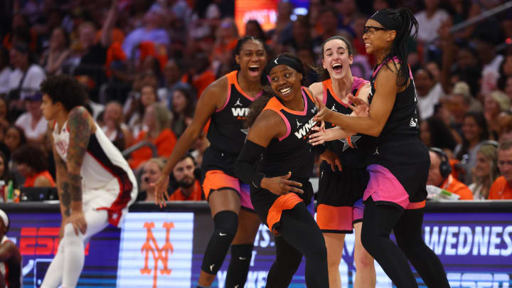 Team WNBA player Arike Ogunbowale celebrates with Caitlin Clark and Allisha Gray