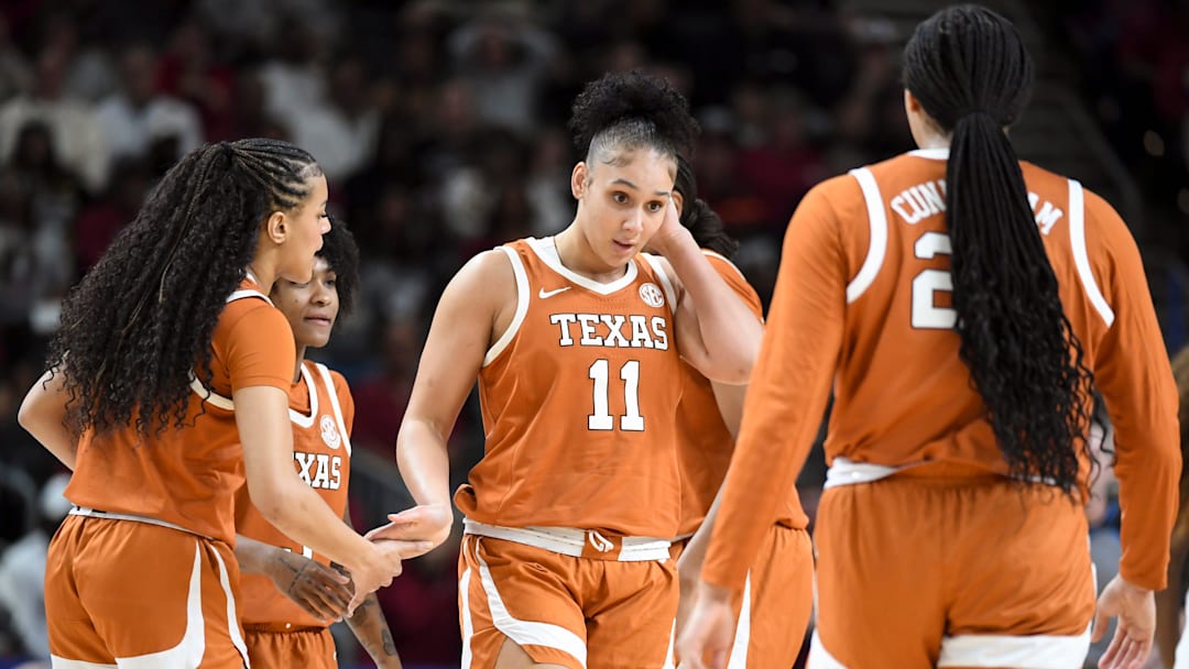 Texas Longhorns forward Justice Carlton high-fives teammates after drawing a South Carolina Gamecocks foul Sunday, March 8, 2026, during the SEC Women's Basketball Tournament Championship game at Bon Secours Wellness Arena in Greenville, South Carolina.