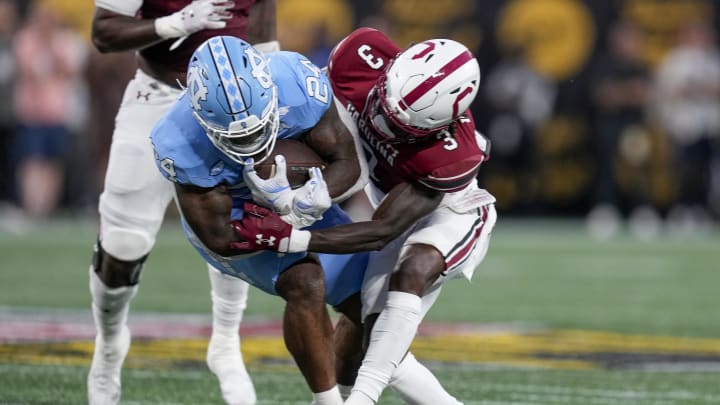 Sep 2, 2023; Charlotte, North Carolina, USA;South Carolina Gamecocks defensive back O'Donnell Fortune (3) tackles North Carolina Tar Heels running back British Brooks (24) during the first quarter at Bank of America Stadium. Mandatory Credit: Jim Dedmon-USA TODAY Sports