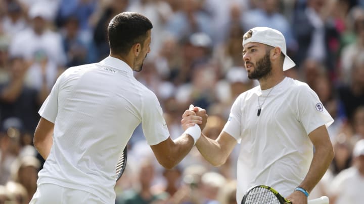 Jul 4, 2024; London, United Kingdom; Novak Djokovic (SRB)(L) shakes hands with Jacob Fearnley (GBR)(R) after their gentlemen's singles match on day four of The Championships Wimbledon 2024 at All England Lawn Tennis and Croquet Club. Mandatory Credit: Geoff Burke-USA TODAY Sports