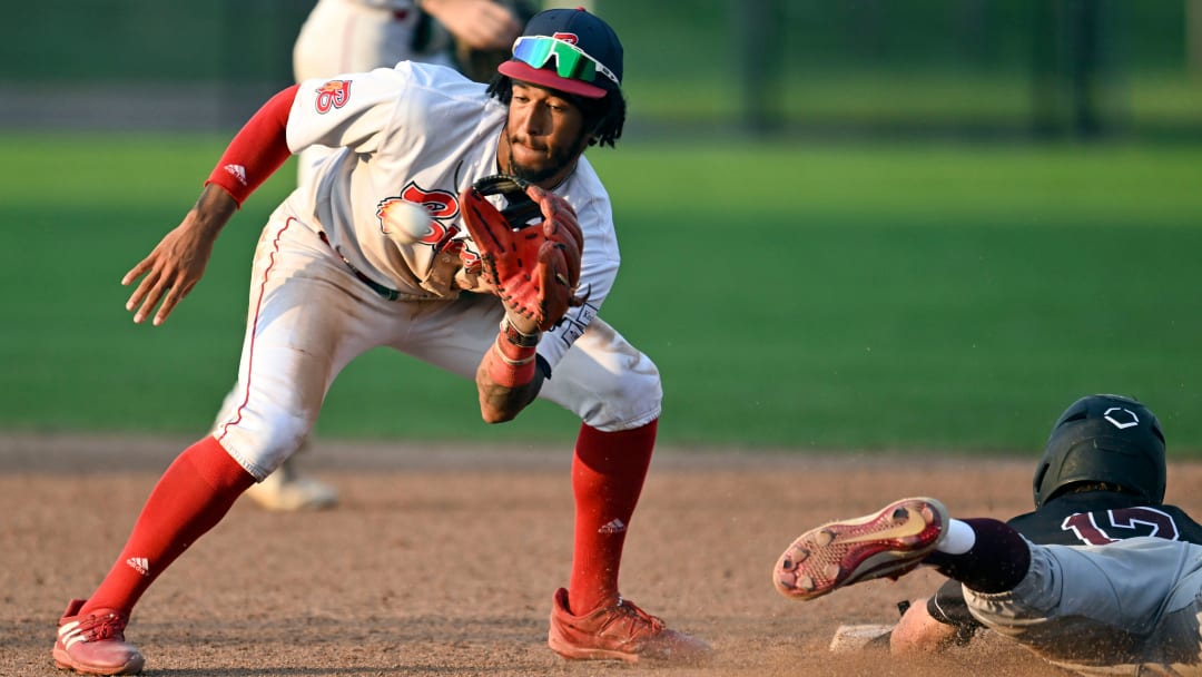 BOURNE   07/13/23   John Spikerman of Falmouth dives safely into second as Josh Kuroda-Grauer of Bourne takes the throw.