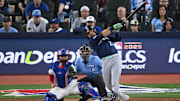 Oct 20, 2025; Toronto, Ontario, CAN; Seattle Mariners third baseman Eugenio Suarez (28) hits a single against the Toronto Blue Jays in the second inning during game seven of the ALCS round for the 2025 MLB playoffs at Rogers Centre. Mandatory Credit: Dan Hamilton-Imagn Images