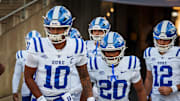 Nov 8, 2025; East Hartford, Connecticut, USA; Duke Blue Devils quarterback Darian Mensah (10) and teammates run onto the field for warm up before the start of the game against the UConn Huskies at Pratt & Whitney Stadium at Rentschler Field. Mandatory Credit: David Butler II-Imagn Images