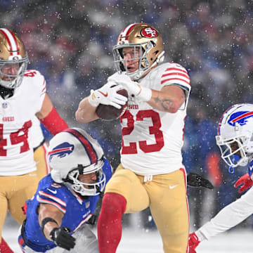 Dec 1, 2024; Orchard Park, New York, USA; San Francisco 49ers running back Christian McCaffrey (23) is tackled by Buffalo Bills safety Taylor Rapp (9) and safety Damar Hamlin (3) in the second quarter at Highmark Stadium. Mandatory Credit: Mark Konezny-Imagn Images