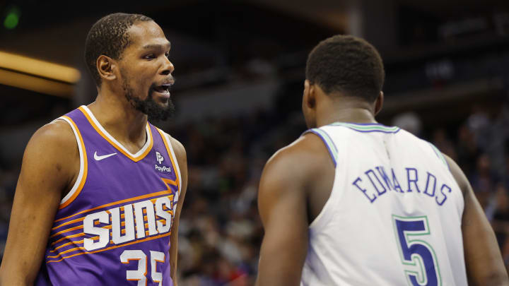 Apr 14, 2024; Minneapolis, Minnesota, USA; Phoenix Suns forward Kevin Durant (35) shares words with Minnesota Timberwolves guard Anthony Edwards (5) after fouling him in the third quarter at Target Center. Mandatory Credit: Bruce Kluckhohn-USA TODAY Sports