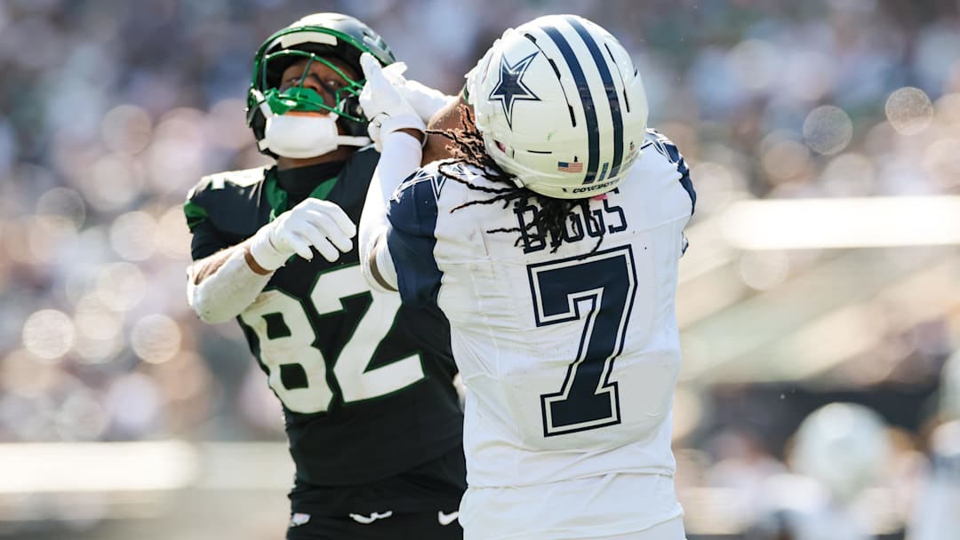 Oct 5, 2025; East Rutherford, New Jersey, USA; Dallas Cowboys cornerback Trevon Diggs (7) battles with New York Jets wide receiver Arian Smith (82) after the whistle during the first half at MetLife Stadium. Mandatory Credit: Vincent Carchietta-Imagn Images