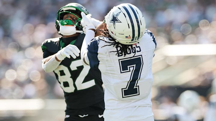 Oct 5, 2025; East Rutherford, New Jersey, USA; Dallas Cowboys cornerback Trevon Diggs (7) battles with New York Jets wide receiver Arian Smith (82) after the whistle during the first half at MetLife Stadium. Mandatory Credit: Vincent Carchietta-Imagn Images