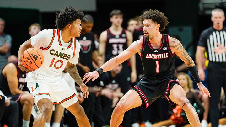 Mar 7, 2026; Coral Gables, Florida, USA; Miami Hurricanes guard Tru Washington (10) dribbles the ball against Louisville Cardinals guard J'vonne Hadley (1) during the second half at Watsco Center. Mandatory Credit: Jeff Romance-Imagn Images