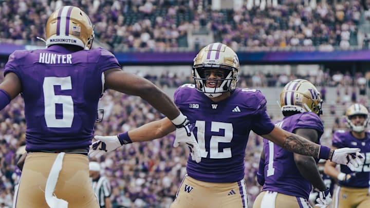 Denzel Boston (12) and Jeremiah Hunter (1) share a Husky Stadium moment. 