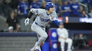 Nov 1, 2025; Toronto, Ontario, CAN; Los Angeles Dodgers two-way player Shohei Ohtani (17) runs to first after hitting a single against the Toronto Blue Jays in the fifth inning during game seven of the 2025 MLB World Series at Rogers Centre. Mandatory Credit: John E. Sokolowski-Imagn Images