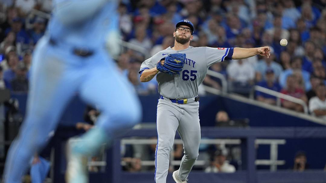 Aug 27, 2026; Toronto, Ontario, CAN;  Kansas City Royals pitcher Noah Cameron (65) throws to first base to force out Toronto Blue Jays second base Charles McAdoo (26) during the third inning at Rogers Centre.  Mandatory Credit: John E. Sokolowski-Imagn Images