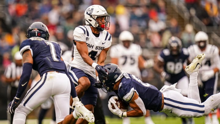 Sep 30, 2023; East Hartford, Connecticut, USA; UConn Huskies linebacker Jackson Mitchell (8) intercepts a pass intended for Utah State Aggies wide receiver Micah Davis (4) in the first quarter at Rentschler Field at Pratt & Whitney Stadium. Mandatory Credit: David Butler II-USA TODAY Sports