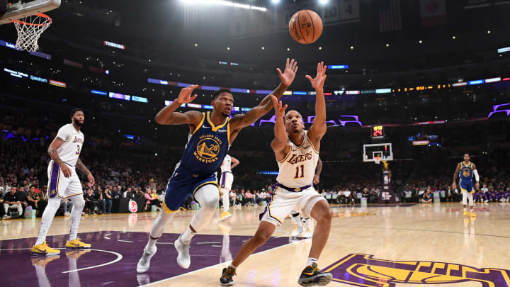 Oct 16, 2019; Los Angeles, CA, USA; Los Angeles Lakers guard Avery Bradley (11) and Golden State Warriors forward Alfonzo McKinnie (28) battle for the ball  in the first half at Staples Center. The Lakers defeated the Warriors 126-93. 