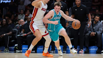 Oct 28, 2025; Miami, Florida, USA; Charlotte Hornets guard Kon Knueppel (7) drives to the basket against Miami Heat forward Nikola Jovic (5) during the second quarter at Kaseya Center. Mandatory Credit: Sam Navarro-Imagn Images