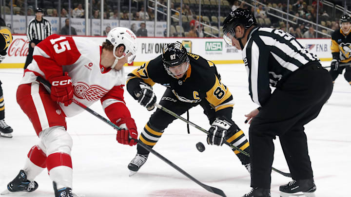 Detroit Red Wings center Sheldon Dries and Pittsburgh Penguins center Sidney Crosby take a face-off.