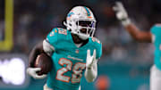 Oct 30, 2025; Miami Gardens, Florida, USA; Miami Dolphins running back De'Von Achane (28) runs for a gain during the first quarter against the Baltimore Ravens at Hard Rock Stadium. 