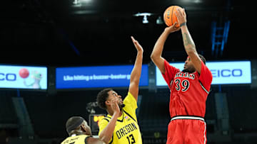 Nov 25, 2025; Las Vegas, Nevada, USA; San Diego State Aztecs guard Reese Dixon-Waters (39) shoots while defended by Oregon Ducks forward Sean Stewart (13) in the second half in a 2025 Players Era Festival group play game at Michelob Ultra Arena.