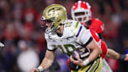 Nov 29, 2024; Athens, Georgia, USA; Georgia Tech Yellow Jackets quarterback Haynes King (10) runs the ball against the Georgia Bulldogs in the third quarter at Sanford Stadium. Mandatory Credit: Brett Davis-Imagn Images