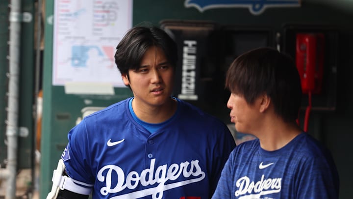 Shohei Ohtani walks in the Dodgers dugout.