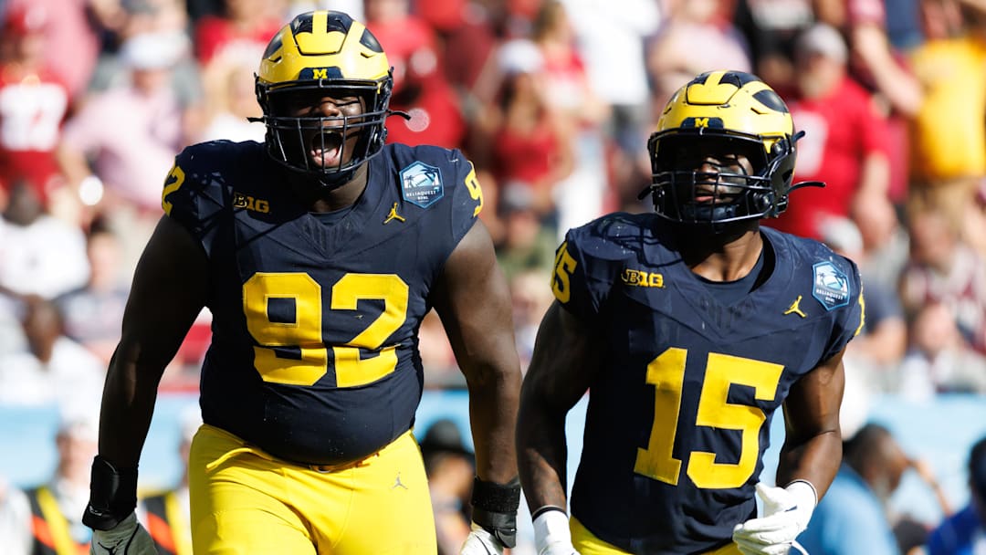 Dec 31, 2024; Tampa, FL, USA; Michigan Wolverines defensive lineman Ike Iwunnah (92) celebrates a sack with Michigan Wolverines linebacker Ernest Hausmann (15) against the Alabama Crimson Tide during the second half at Raymond James Stadium. Mandatory Credit: Matt Pendleton-Imagn Images