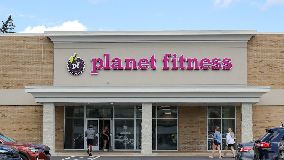 People walk into a Planet Fitness gym.