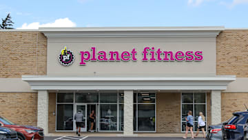 People walk into a Planet Fitness gym.