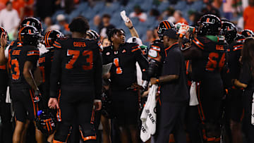 Oct 26, 2024; Miami Gardens, Florida, USA; Miami Hurricanes quarterback Cam Ward (1) looks on from the sideline during a timeout against the Florida State Seminoles in the fourth quarter at Hard Rock Stadium. Mandatory Credit: Sam Navarro-Imagn Images