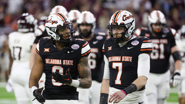 Dec 27, 2023; Houston, TX, USA; Oklahoma State Cowboys running back Ollie Gordon II (0) talks to quarterback Alan Bowman (7) after the Cowboys turned over the ball on downs against the Texas A&M Aggies in the second half at NRG Stadium. Mandatory Credit: Thomas Shea-USA TODAY Sports