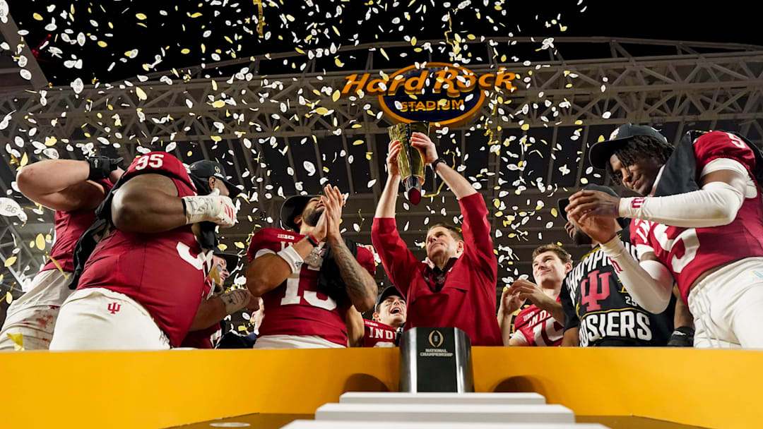Indiana Hoosiers head coach Curt Cignetti hoists the championship trophy Monday, Jan. 19, 2026, after defeating the Miami (FL) Hurricanes in the College Football Playoff National Championship college football game at Hard Rock Stadium in Miami Gardens.