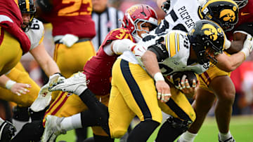 Nov 15, 2025; Los Angeles, California, USA; Iowa Hawkeyes running back Kamari Moulton (28) runs the ball against Southern California Trojans linebacker Jadyn Walker (31) during the second half at the Los Angeles Memorial Coliseum. Mandatory Credit: Gary A. Vasquez-Imagn Images
