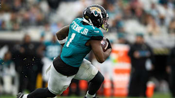 Dec 29, 2024; Jacksonville, Florida, USA; Jacksonville Jaguars running back Travis Etienne Jr (1) runs the ball against the Tennessee Titans in the third quarter at EverBank Stadium. Mandatory Credit: Jeremy Reper-Imagn Images