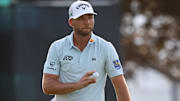 Sam Burns reacts after putting on the 18th green during the third round of the U.S. Open golf tournament. 