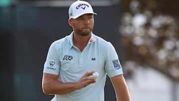 Sam Burns reacts after putting on the 18th green during the third round of the U.S. Open golf tournament. 