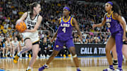 Apr 1, 2024; Albany, NY, USA; Iowa Hawkeyes guard Caitlin Clark (22) controls the ball against LSU Lady Tigers guard Flau'jae Johnson (4) and LSU Lady Tigers forward Angel Reese (10) in the third quarter in the finals of the Albany Regional in the 2024 NCAA Tournament at MVP Arena. Mandatory Credit: Gregory Fisher-Imagn Images