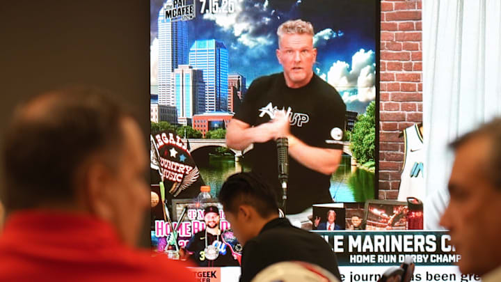 Journalists watch a television at the Pro Football Hall of Fame waiting for Pat McAfee, the host of The Pat McAfee Show on ESPN to announce that he will broadcast live from the Hall of Fame on July 31 ahead of this year's Hall of Fame Game between the Detroit Lions and the Los Angeles Chargers. Tuesday, July 15, 2025.