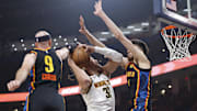May 7, 2025; Oklahoma City, Oklahoma, USA; Oklahoma City Thunder guard Alex Caruso (9) and forward Chet Holmgren (7) defend a shot by Denver Nuggets forward Aaron Gordon (32) in the second quarter during game two of the second round for the 2025 NBA Playoffs at Paycom Center. Mandatory Credit: Alonzo Adams-Imagn Images