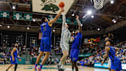 Jan 30, 2025; New Orleans, Louisiana, USA;  Tulane Green Wave guard Rowan Brumbaugh (7) drives to the basket against Memphis Tigers forward Dain Dainja (42) during the second half at Avron B. Fogelman Arena in Devlin Fieldhouse.