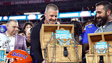 Dec 20, 2024; Tampa, FL, USA; Florida Gators head coach Billy Napier is presented the Gasparilla Bowl championship trophy after the win against the Tulane Green Wave at Raymond James Stadium. Mandatory Credit: Kim Klement Neitzel-Imagn Images