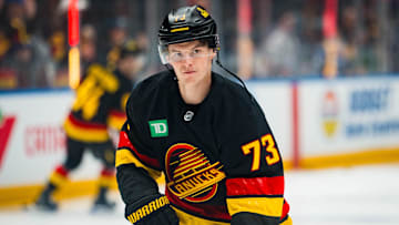 Oct 28, 2025; Vancouver, British Columbia, CAN; Vancouver Canucks forward Lukas Reichel (73) shoots  during warm up prior to a game against the New York Rangers at Rogers Arena. Mandatory Credit: Bob Frid-Imagn Images