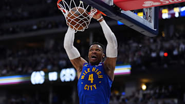 Apr 19, 2025; Denver, Colorado, USA; Denver Nuggets guard Russell Westbrook (4) finishes off a dunk in the fourth quarter against the LA Clippers at Ball Arena. Mandatory Credit: Ron Chenoy-Imagn Images