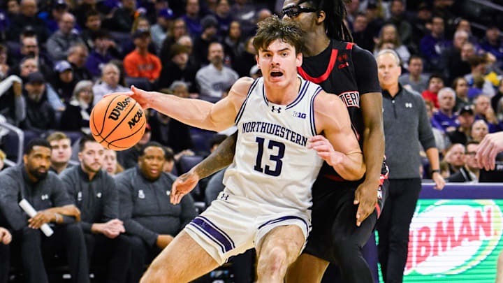 Dec 29, 2024; Evanston, Illinois, USA; Northwestern Wildcats guard Brooks Barnhizer (13) moves the ball against Northeastern Huskies guard Harold Woods (10)  during the second half at Welsh-Ryan Arena. Mandatory Credit: Matt Marton-Imagn Images