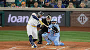 Oct 17, 2025; Seattle, Washington, USA; Seattle Mariners first baseman Josh Naylor (12) hits a single against the Toronto Blue Jays in the fourth inning during game five of the ALCS round for the 2025 MLB playoffs at T-Mobile Park. Mandatory Credit: John Froschauer-Imagn Images