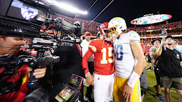 Sep 15, 2022; Kansas City, Missouri, USA; Los Angeles Chargers quarterback Justin Herbert (10) meets with Kansas City Chiefs quarterback Patrick Mahomes (15) following the game at GEHA Field at Arrowhead Stadium. Mandatory Credit: Jay Biggerstaff-Imagn Images