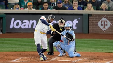 Oct 17, 2025; Seattle, Washington, USA; Seattle Mariners first baseman Josh Naylor (12) hits a single against the Toronto Blue Jays in the fourth inning during game five of the ALCS round for the 2025 MLB playoffs at T-Mobile Park. Mandatory Credit: John Froschauer-Imagn Images
