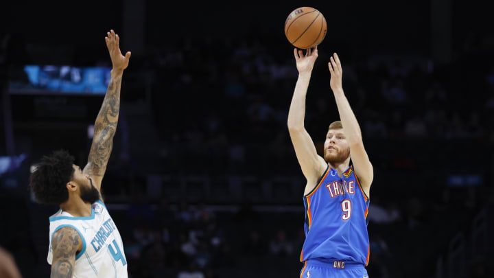 Oct 15, 2023; Charlotte, North Carolina, USA; Oklahoma City Thunder forward Davis Bertans (9) shoots over Charlotte Hornets center Nick Richards (4) in the first half at Spectrum Center. Mandatory Credit: Nell Redmond-USA TODAY Sports