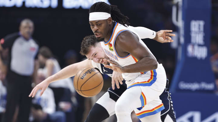 May 7, 2024; Oklahoma City, Oklahoma, USA; Oklahoma City Thunder guard Luguentz Dort (5) steals the ball from Dallas Mavericks guard Luka Doncic (77) during the first quarter of game one of the second round for the 2024 NBA playoffs at Paycom Center. Mandatory Credit: Alonzo Adams-USA TODAY Sports