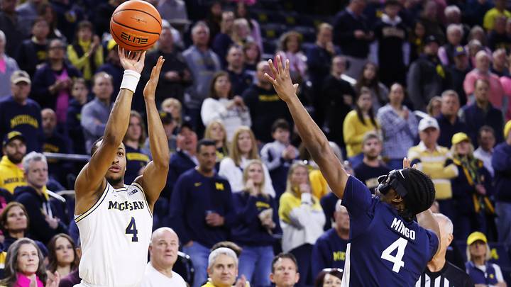 Feb 5, 2026; Ann Arbor, Michigan, USA;  Michigan Wolverines guard Nimari Burnett (4) shoots against Penn State Nittany Lions guard Kayden Mingo (4) in the first half at Crisler Center. Mandatory Credit: Rick Osentoski-Imagn Images